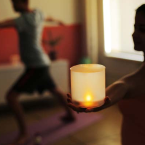 yoga pose with solar candles in hand