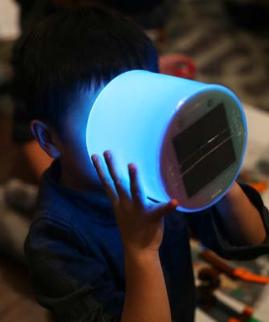 boy holding luci color (blue) solar inflatable light